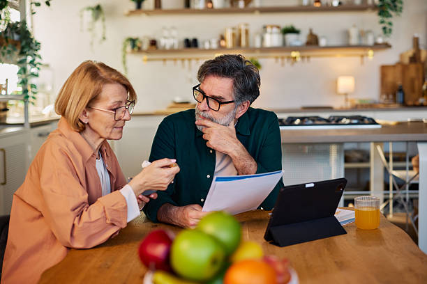 Couple comparing health insurance plans at the kitchen table